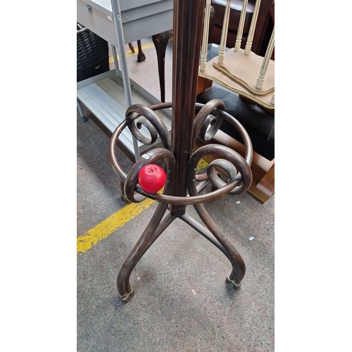 673 - Star Lot : A Large oversized Antique bentwood coat stand, featuring ornate curved arms and tripod ba... 