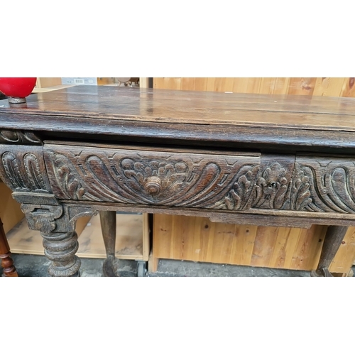 683 - Star Lot : An early Antique plank console table with carved detailing, two spacious drawers, and tur... 