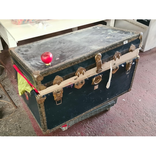 766 - A fabulous large vintage hard shell storage trunk featuring metal studded hardware and leather handl... 