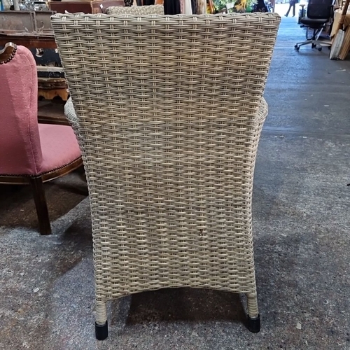 964 - Pair of woven rattan armchairs with sturdy metal frames and a natural finish.