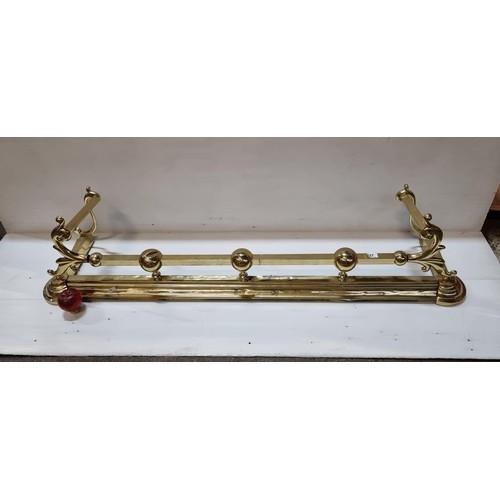 1016 - A polished brass fire fender with scroll work fire dogs.
MM: W 135cm x D 30cm.
Previous in auction o... 