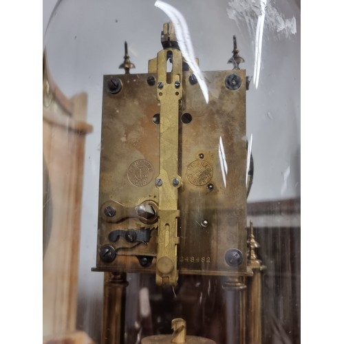 276 - A wonderful antique brass torsion pendulum anniversary clock, housed under a glass dome with a stepp... 