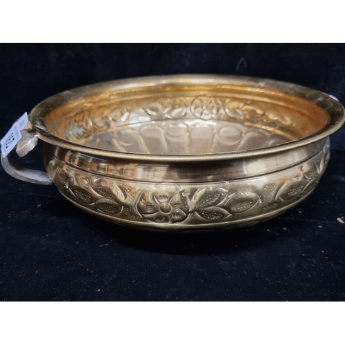 290 - A polished brass planter with floral border.