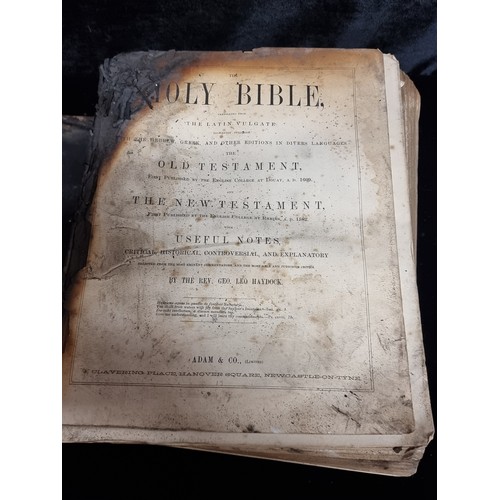 296 - A large mid 19th century copy of The Holy Bible by The Rev. Geo Leo Haydock. Leather bound. Has suff... 