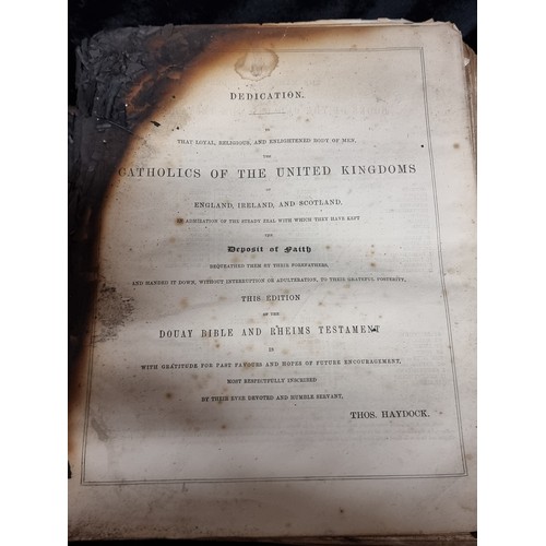 296 - A large mid 19th century copy of The Holy Bible by The Rev. Geo Leo Haydock. Leather bound. Has suff... 