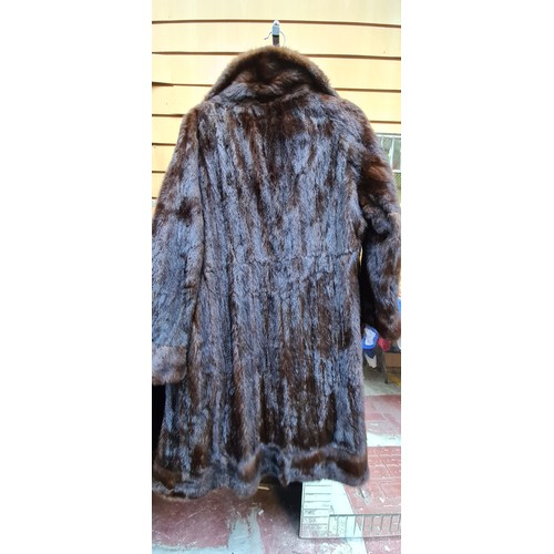 373 - Star lot : A beautiful vintage Barnardo Dublin genuine fur longline coat in brown. Size approx. medi... 