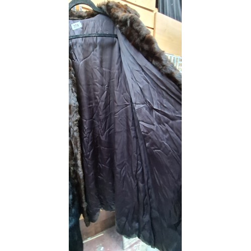 374 - Star lot : A stunning vintage genuine fur longline coat. Approx. size medium.