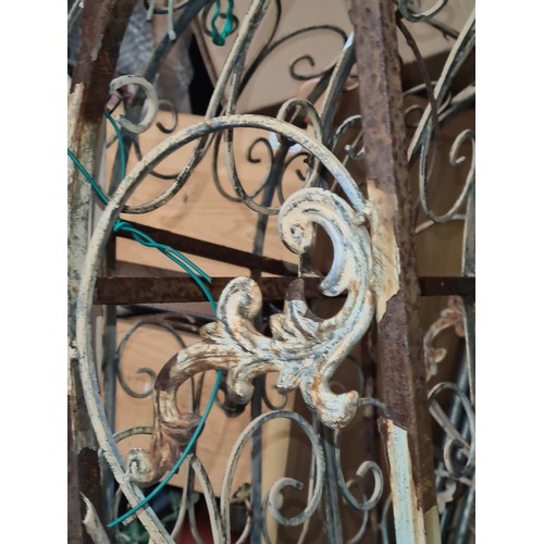 767 - Two vintage wrought iron Arch climber boasting beautiful intricate floral decoration. In need of som... 