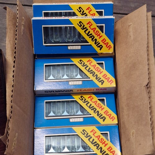 733 - A box of vintage camera equipment including a box of Sylvania flash bars, a Kodak slide tray carouse... 