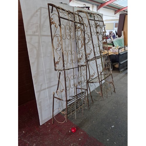 767 - Two vintage wrought iron Arch climber boasting beautiful intricate floral decoration. In need of som... 