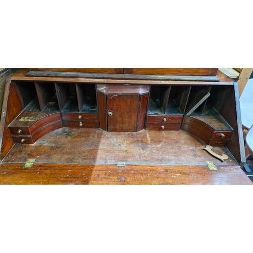 988 - Star lot :An Irish Georgian writing desk with lots of pigeon holes, four drawers and bracket feet.