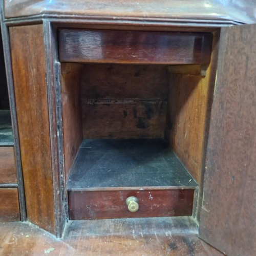 988 - Star lot :An Irish Georgian writing desk with lots of pigeon holes, four drawers and bracket feet.