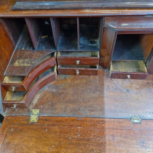 988 - Star lot :An Irish Georgian writing desk with lots of pigeon holes, four drawers and bracket feet.