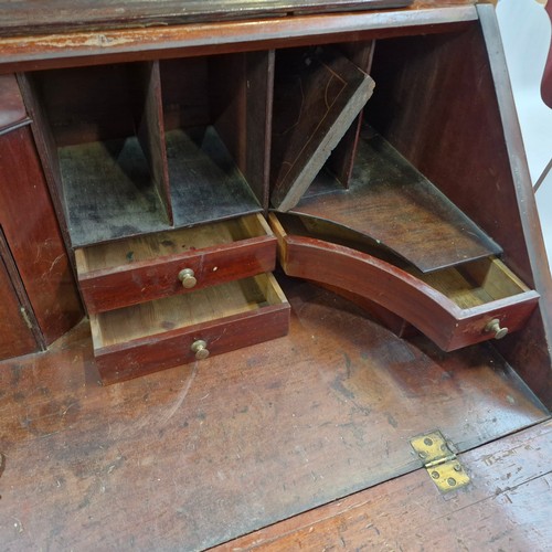 988 - Star lot :An Irish Georgian writing desk with lots of pigeon holes, four drawers and bracket feet.