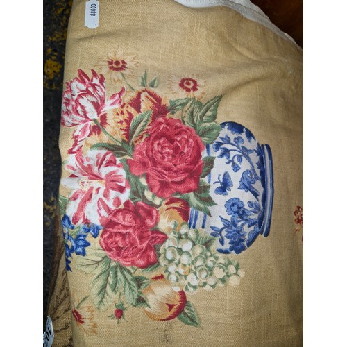 1035 - Three items. Includes two rolls of fabric. Features floral prints. Along with a vintage cushion. All... 