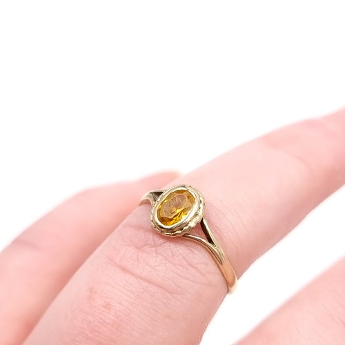 637 - A very demure 9ct gold ring with an oval citrine. 1.2 grams. Size L