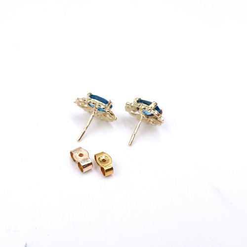 6 - A pretty pair of nine carat gold topaz stud earrings. Weight - 1.9 grams.