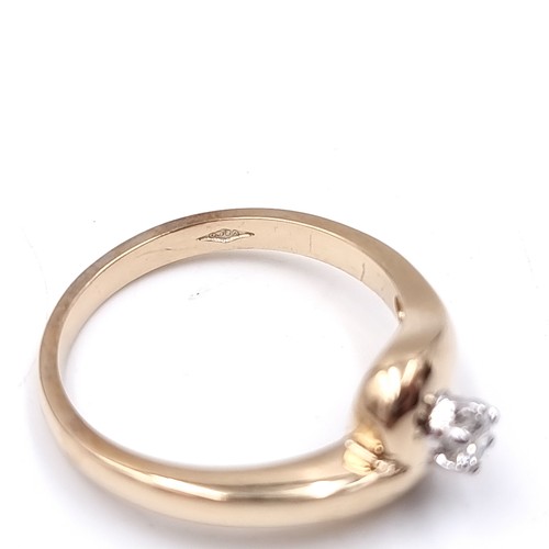 10 - A nine carat gold solitaire diamond ring. Size - M. Weight - 3.1 grams.