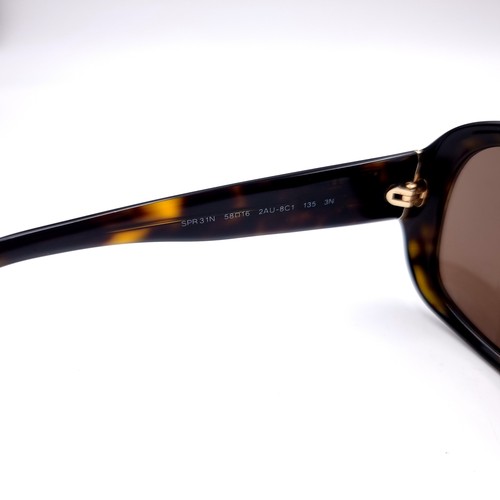 13 - A pair of Genuine designer Prada faux tortoise shell framed sunglasses in good condition with serial... 