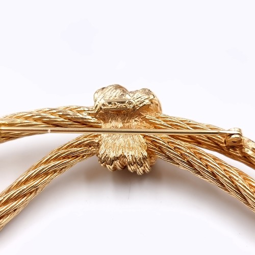 21 - A pretty original Christian Dior knot rope brooch. Length - 9 cms. Weight - 30.75 grams.