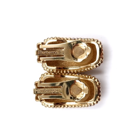 528 - A pair of Burberry gold metal clasp earrings. Weight - 25.6 grams.