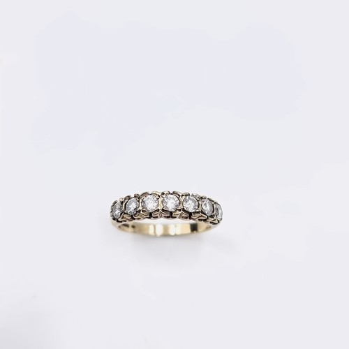 567 - Star Lot : An outstanding seven stone diamond half eternity ring set in nine carat gold. Est. weight... 