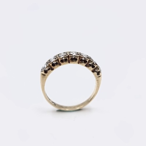 567 - Star Lot : An outstanding seven stone diamond half eternity ring set in nine carat gold. Est. weight... 