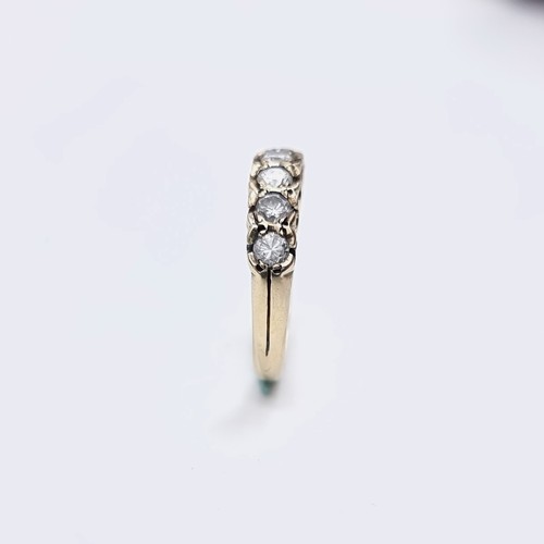 567 - Star Lot : An outstanding seven stone diamond half eternity ring set in nine carat gold. Est. weight... 