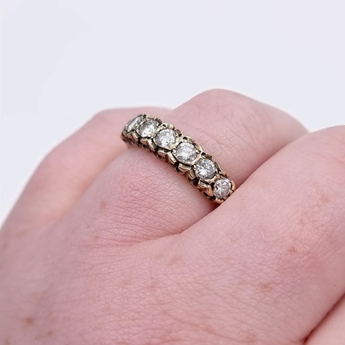 567 - Star Lot : An outstanding seven stone diamond half eternity ring set in nine carat gold. Est. weight... 