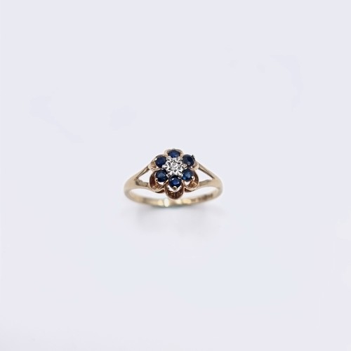 574 - Star Lot A nine carat gold sapphire & diamond ring. Size - H. Weight - 1.15 grams. Boxed.