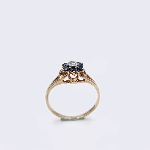 574 - Star Lot A nine carat gold sapphire & diamond ring. Size - H. Weight - 1.15 grams. Boxed.