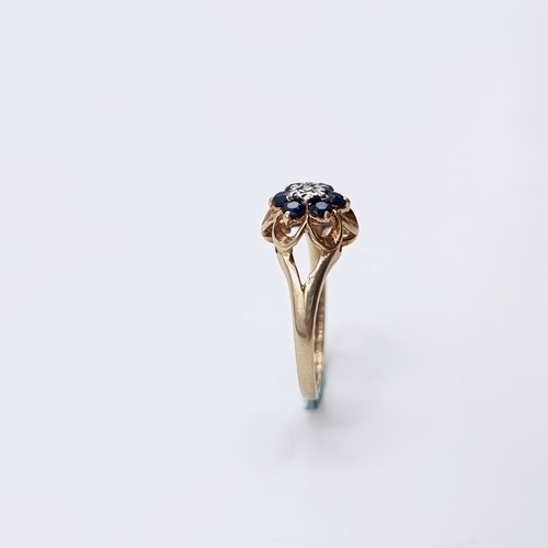 574 - Star Lot A nine carat gold sapphire & diamond ring. Size - H. Weight - 1.15 grams. Boxed.