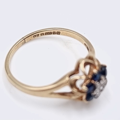 574 - Star Lot A nine carat gold sapphire & diamond ring. Size - H. Weight - 1.15 grams. Boxed.