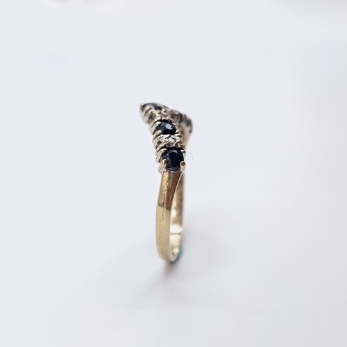 577 - Star Lot : A nine carat gold wishbone diamond and sapphire half eternity ring. Ring size - O. Weight... 