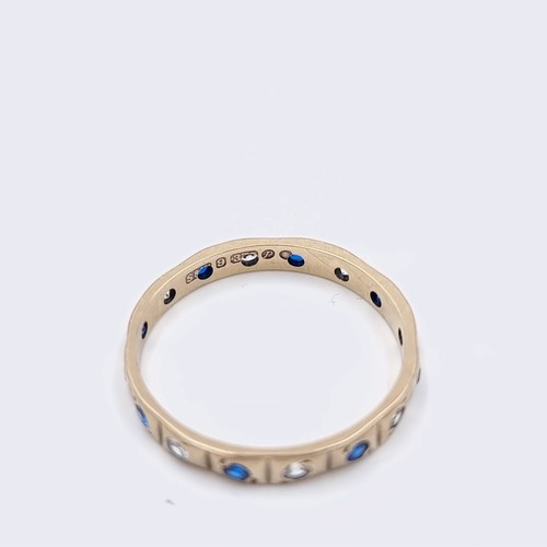 578 - Star Lot : A nine carat gold gem set full eternity ring. Size - O. Weight - 1.55 grams. Boxed.