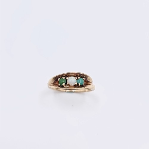 581 - Star Lot : A nine carat gold opal and jade ring. Size - M. Weight - 3.2 grams. Boxed.