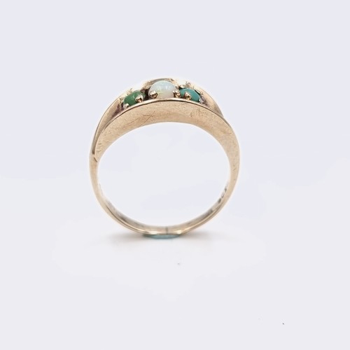 581 - Star Lot : A nine carat gold opal and jade ring. Size - M. Weight - 3.2 grams. Boxed.