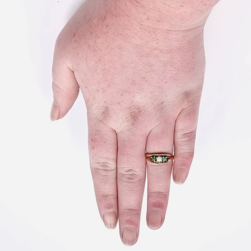 581 - Star Lot : A nine carat gold opal and jade ring. Size - M. Weight - 3.2 grams. Boxed.