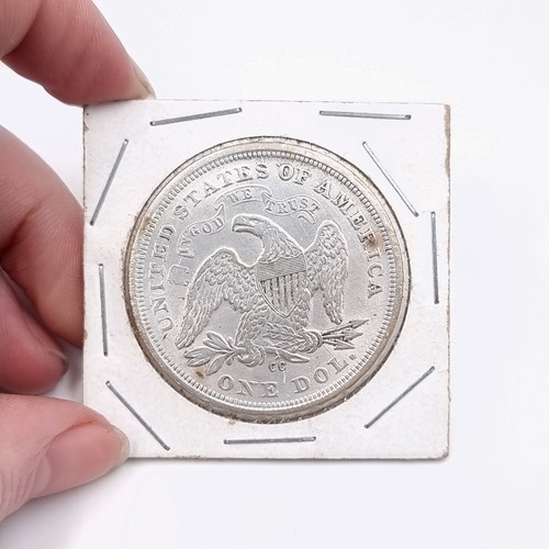 600 - Star Lot : A rare mounted USA silver dollar coin dated 1864.