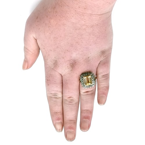 1 - Star Lot : A nine carat gold citrine stone ring set with Alexandrite surround. Size - O. Weight - 5.... 