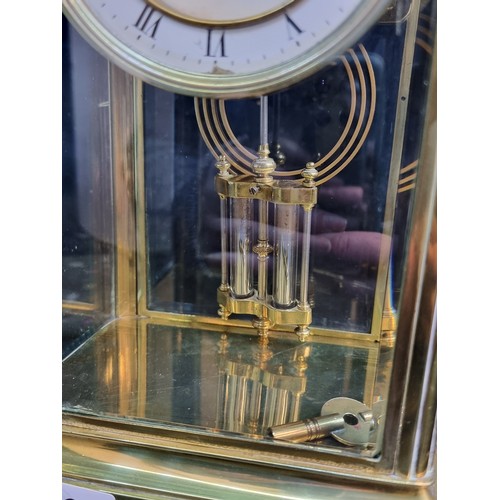 126 - Star Lot : A stunning large Edwardian brass and glass cased tall mantle clock featuring white enamel... 