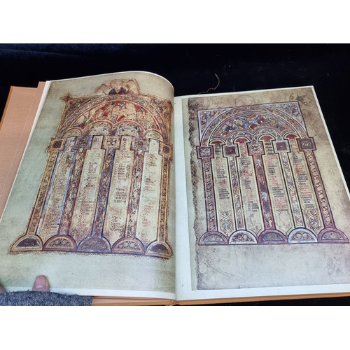 165 - A vintage hardback book copy of The Book of Kells. Features gilt embossed cloth cover and slip.