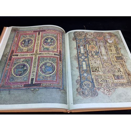 165 - A vintage hardback book copy of The Book of Kells. Features gilt embossed cloth cover and slip.