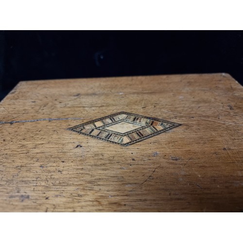 193 - An antique wooden writing slope with marquetry design to top.