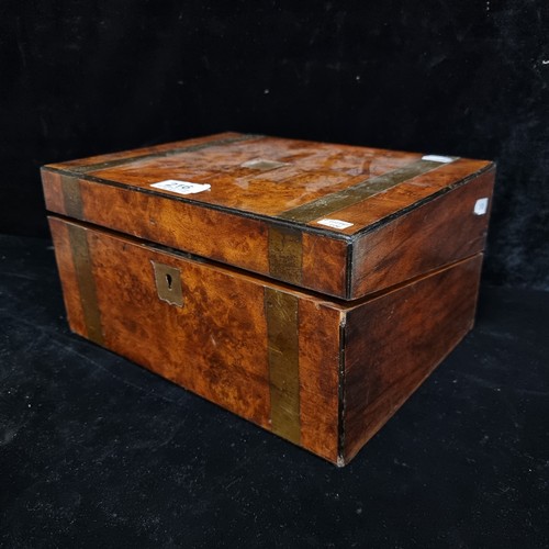 216 - An antique burl walnut writing slope with brass hardware and cartouche. Some attention needed to hin... 