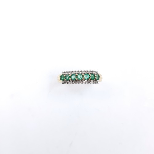 6 - Star Lot : A fine emerald & diamond half eternity ring set in nine carat gold. Ring size - R. Weight... 