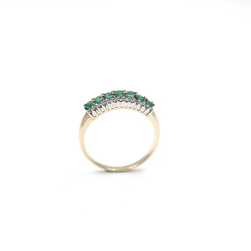 6 - Star Lot : A fine emerald & diamond half eternity ring set in nine carat gold. Ring size - R. Weight... 