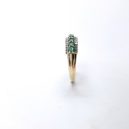 6 - Star Lot : A fine emerald & diamond half eternity ring set in nine carat gold. Ring size - R. Weight... 