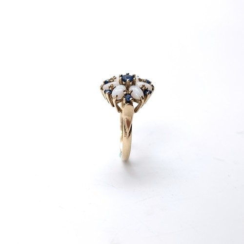 8 - Star Lot : A very attractive daisy style nine carat gold ring set with sapphire & opal surround. Siz... 