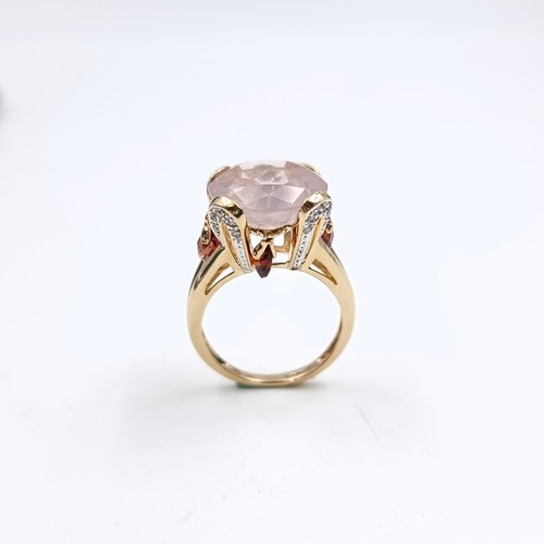 9 - Star lot : A very large pink topaz  ring set in nine carat gold with claw mount. Size - O 1/2. Weigh... 